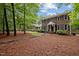 Charming brick home with black shutters, an American flag, and a well-maintained lawn and landscaping at 102 Mel Oak Dr, Chapel Hill, NC 27516
