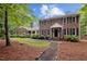 Charming brick home with black shutters, an American flag, and a well-manicured lawn at 102 Mel Oak Dr, Chapel Hill, NC 27516