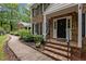 Charming brick home featuring an inviting front porch with mature landscaping and a brick walkway at 102 Mel Oak Dr, Chapel Hill, NC 27516