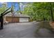 A paved driveway leads to a brick garage with a basketball hoop at 102 Mel Oak Dr, Chapel Hill, NC 27516