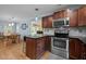 Open kitchen featuring stainless steel appliances, granite counters, and access to the dining area at 102 Mel Oak Dr, Chapel Hill, NC 27516