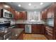 Well-appointed kitchen featuring granite countertops, stainless steel appliances, and wood cabinetry at 102 Mel Oak Dr, Chapel Hill, NC 27516