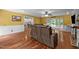 Open-concept living room filled with natural light features hardwood floors and comfortable leather furniture at 102 Mel Oak Dr, Chapel Hill, NC 27516