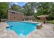 Beautiful home features an in-ground pool, stone patio, and a private backyard oasis at 102 Mel Oak Dr, Chapel Hill, NC 27516