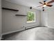 Minimalist room with a large window, floating shelves, and concrete flooring at 102 Mel Oak Dr, Chapel Hill, NC 27516