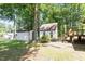 Backyard featuring detached garage, shed, and wooden deck at 103 Castill Pl, Garner, NC 27529