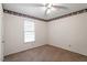 Bedroom with ceiling fan, window, and decorative border at 103 Castill Pl, Garner, NC 27529