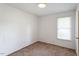 Bedroom features a window and neutral carpet at 103 Castill Pl, Garner, NC 27529