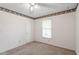 Bedroom with ceiling fan, window, and decorative border at 103 Castill Pl, Garner, NC 27529