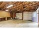 Unfinished garage area shows the rafters, walls, and garage doors at 103 Castill Pl, Garner, NC 27529
