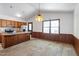 Eat-in kitchen featuring wood cabinets and a large window at 103 Castill Pl, Garner, NC 27529