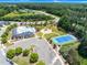 Aerial view of community amenities featuring a pool, playground, tennis court, and parking area at 106 Elmsford St, Durham, NC 27703
