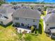 Aerial view of home's backyard with a patio, fire pit, landscaped area, and adjacent lawn at 106 Elmsford St, Durham, NC 27703