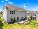 Exterior view of home showcasing a spacious backyard patio with seating, fire pit, and beautiful landscaping at 106 Elmsford St, Durham, NC 27703