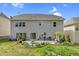 Rear view of a two-story home with a well-manicured lawn, patio, and outdoor living space at 106 Elmsford St, Durham, NC 27703