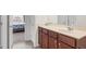Bathroom featuring tile floors, wood cabinets, a marble-look countertop, and an open doorway to the bedroom at 106 Elmsford St, Durham, NC 27703
