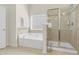 Bathroom showcasing a soaking tub, tiled shower with glass door, and linen storage, creating a relaxing and luxurious space at 106 Elmsford St, Durham, NC 27703