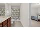 Bathroom features wood cabinets, a marble-look countertop, and a shower with modern curtain at 106 Elmsford St, Durham, NC 27703