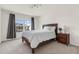 Cozy bedroom featuring a comfortable bed, bedside table, and window offering natural light and neighborhood views at 106 Elmsford St, Durham, NC 27703