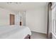 Bright bedroom with neutral walls, plush carpeting, and a view towards an ensuite bathroom, offering comfort and convenience at 106 Elmsford St, Durham, NC 27703