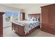 Bedroom with a large window, blue and white bedding, and wood furniture pieces at 106 Elmsford St, Durham, NC 27703