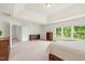 Expansive bedroom featuring large windows with nature views, a neutral color palette, and ample space for relaxation at 106 Elmsford St, Durham, NC 27703