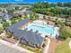 Aerial view showcasing a sparkling community pool with lounge chairs, clubhouse, and nearby playground at 106 Elmsford St, Durham, NC 27703