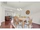 Open dining room featuring wood table and chairs, chandelier, and a connection to the living room at 106 Elmsford St, Durham, NC 27703