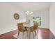 Traditional dining room with a light wood table and chairs, and a decorative wall clock at 106 Elmsford St, Durham, NC 27703