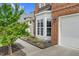Close-up of the brick exterior with a bright bay window and a two-car garage door at 106 Elmsford St, Durham, NC 27703