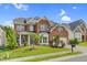 Beautiful two-story brick home with manicured lawn, gray shutters, and attached two car garage at 106 Elmsford St, Durham, NC 27703