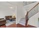 Welcoming foyer with gleaming hardwood floors, staircase, and a glimpse into the cozy living room at 106 Elmsford St, Durham, NC 27703