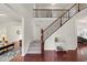 Grand foyer featuring hardwood floors, a staircase with iron spindles, and views into living spaces at 106 Elmsford St, Durham, NC 27703
