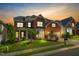 Elegant two-story red brick home with a well-manicured lawn and a two-car garage at sunset at 106 Elmsford St, Durham, NC 27703