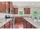 Gourmet kitchen featuring stainless steel appliances, granite countertops, and cherry cabinets at 106 Elmsford St, Durham, NC 27703