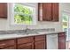 Kitchen sink with granite countertop, stainless dishwasher, cherry cabinets and backyard view at 106 Elmsford St, Durham, NC 27703