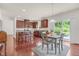 Bright kitchen with cherry cabinets, granite counters, and stainless appliances with a view to the backyard at 106 Elmsford St, Durham, NC 27703