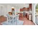 Open kitchen featuring wood floors, cherry cabinets, granite counters, and a dining area at 106 Elmsford St, Durham, NC 27703