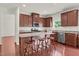 Kitchen island with granite counters, dark wood cabinets, and stainless appliances at 106 Elmsford St, Durham, NC 27703