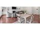 Open-concept living room with fireplace, built-ins, dining table, and light gray furnishings at 106 Elmsford St, Durham, NC 27703