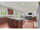 Open floor plan featuring a kitchen with a center island, a dining area, and a living room at 106 Elmsford St, Durham, NC 27703