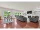 Open-concept living room featuring a gas fireplace, built-in shelving, and outside view at 106 Elmsford St, Durham, NC 27703