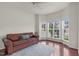 Bright living room featuring a comfortable brown leather sofa and a bay window at 106 Elmsford St, Durham, NC 27703