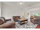 Cozy living room with two leather sofas, two armchairs, and a decorative area rug at 106 Elmsford St, Durham, NC 27703
