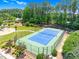 Aerial view of a fenced community tennis court surrounded by lush landscaping at 106 Elmsford St, Durham, NC 27703