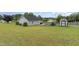 Sprawling backyard featuring a patio, storage shed, and carport, providing ample space for outdoor activities at 109 D A King Dr, Willow Springs, NC 27592