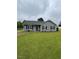 Single-story home with gray siding, black shutters and a well-manicured lawn at 109 D A King Dr, Willow Springs, NC 27592