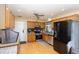 Well-equipped kitchen with wooden cabinets, stainless steel appliances, and tile backsplash at 109 D A King Dr, Willow Springs, NC 27592