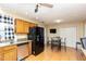 Functional kitchen featuring wooden cabinetry, stainless steel appliances, and an adjacent dining area at 109 D A King Dr, Willow Springs, NC 27592
