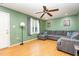 Inviting living room with hardwood floors, a comfortable gray sectional, and ample natural light at 109 D A King Dr, Willow Springs, NC 27592